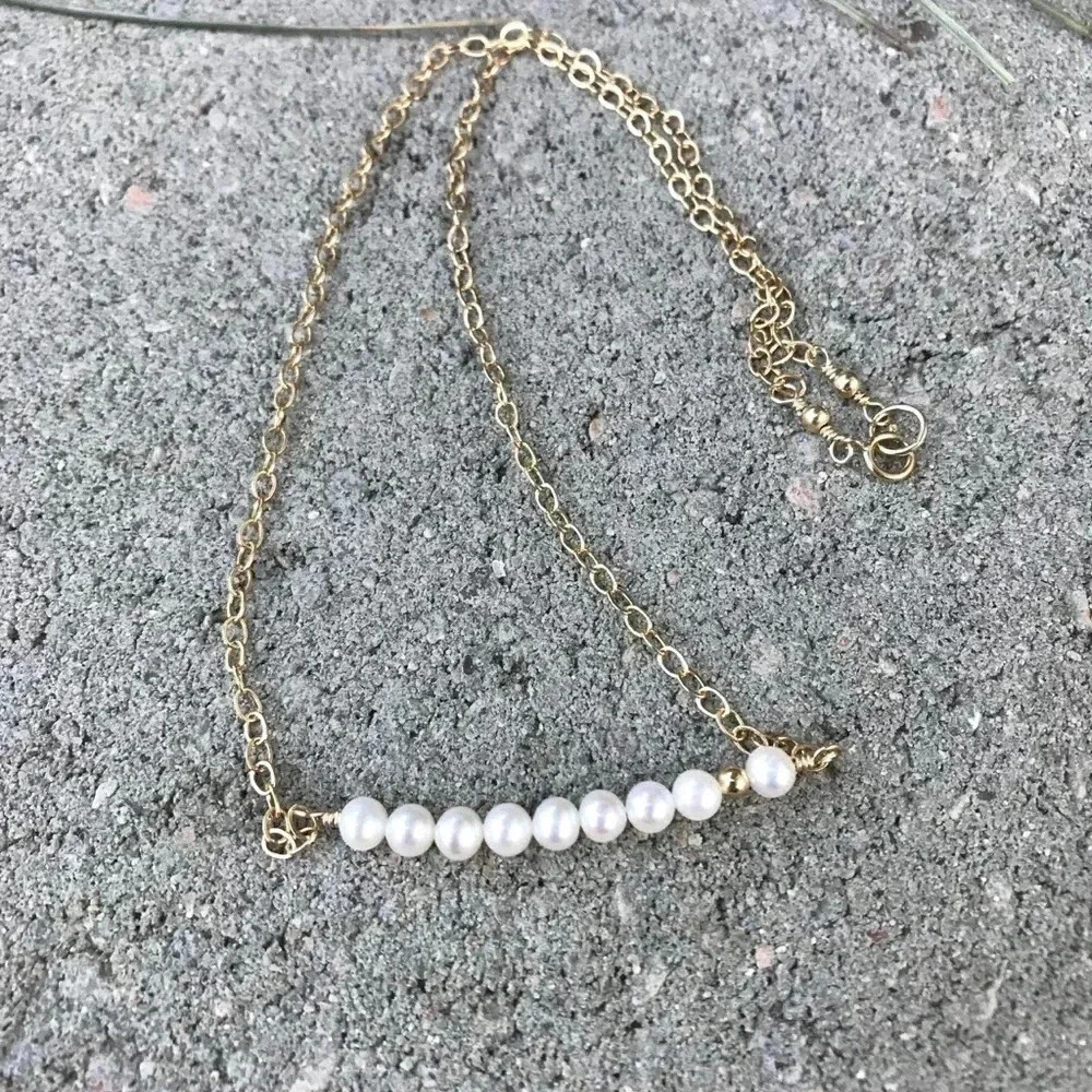 Silver-toned drop pearl necklace photographed for a marketplace product listing